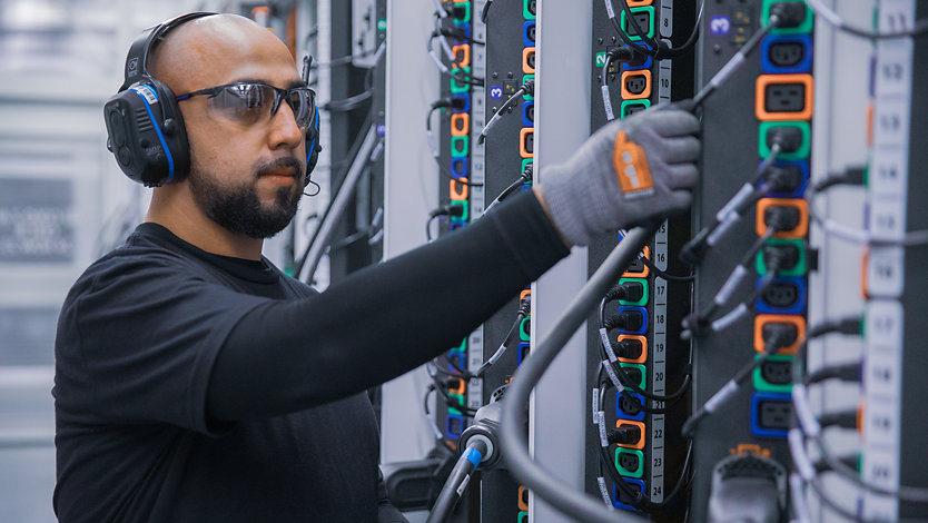 An employee checks servers in a cloud data center. 