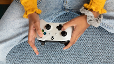 A young girl holding the Xbox controller. 