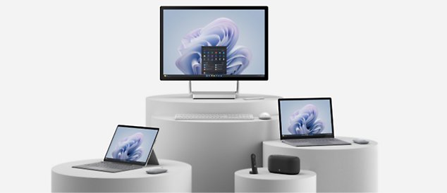 Um desktop tudo em um, um notebook, um tablet e um alto-falante com controle remoto dispostos em várias mesas redondas
