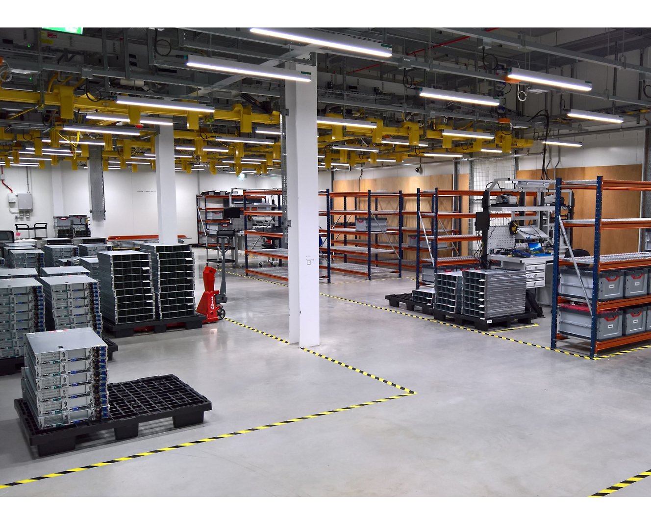 A large warehouse with many racks and shelves.