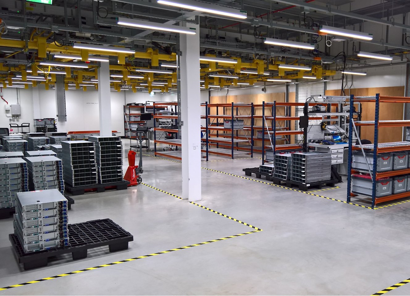 A large warehouse with many racks and shelves.