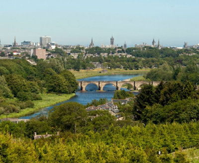 Picture of a city taken from a green lush garden or view