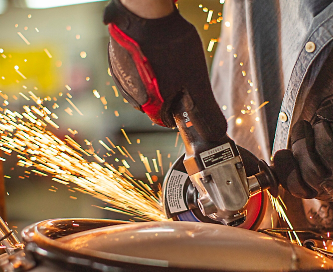 A power tool cutting metal and sparks are flying