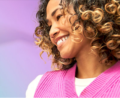 A woman with curly hair smiling