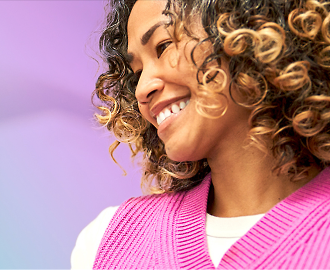 A woman with curly hair smiling