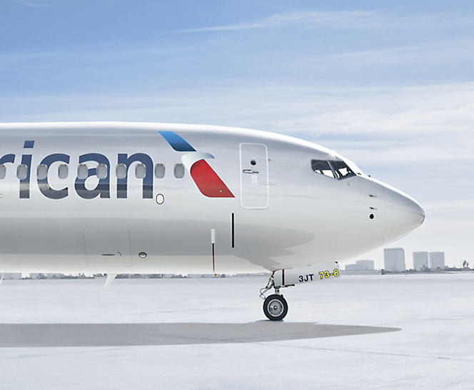 An American Airlines airplane sits on the tarmac.
