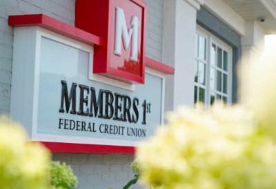 A image of Customer Stories Members 1st logo on a building
