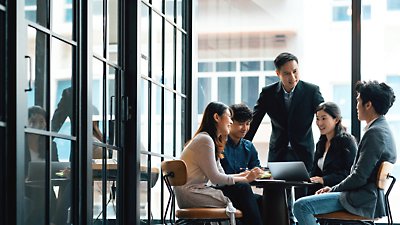 A group of business people sitting around a table.