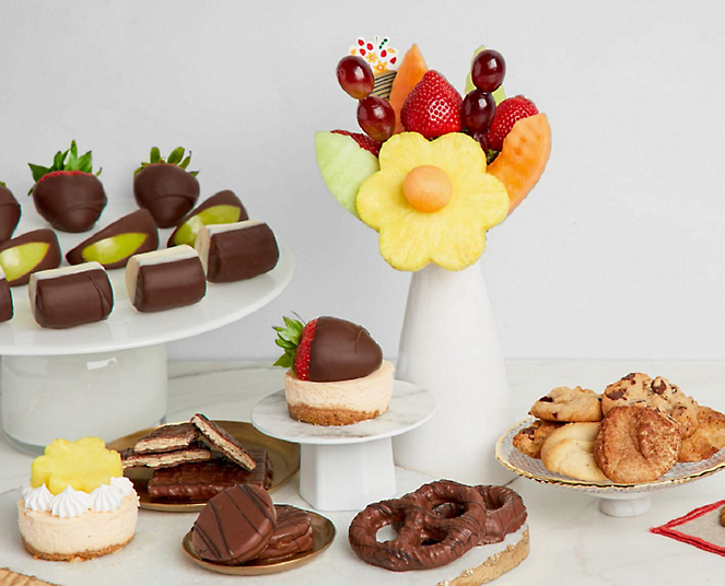 A variety of desserts and pastries are displayed on a table.