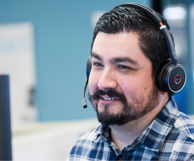 A man smiling and wearing headphones