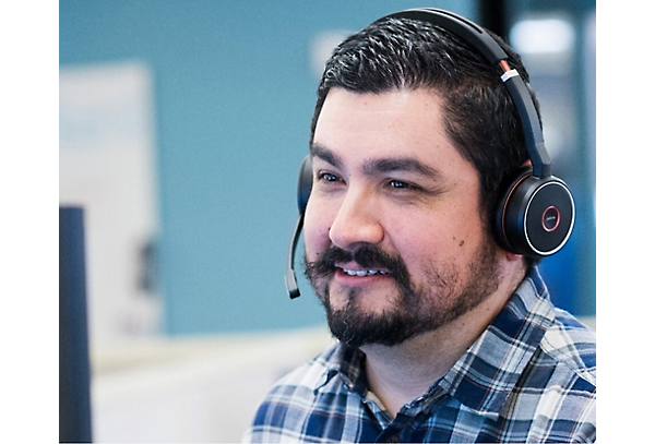 A man smiling and wearing headphones
