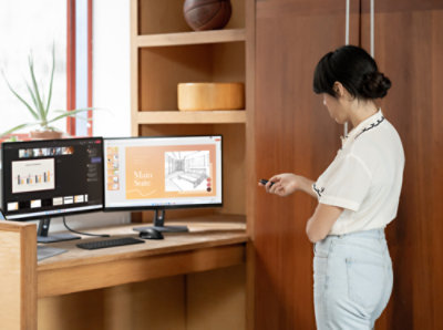 A girl standing in front of a computer