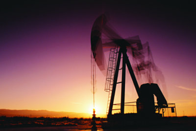 A sillhouette of outdoor machinery in the sunset