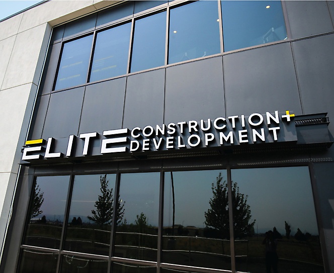 an outside view of a building company named elite construction development
