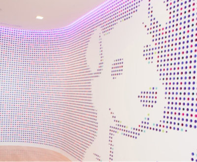 A room with a colorful dotted dog picture in the wall