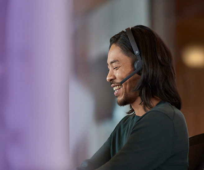 A person wearing a headset smilling