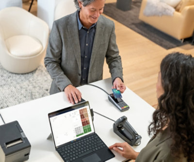 A person paying with credit card on a store