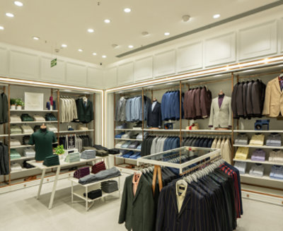 A store with many clothes on swingers