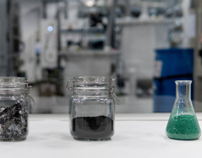 A group of glass jars with colored powder