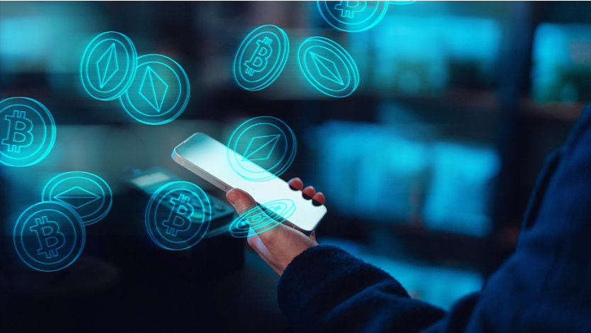 A person using a smartphone surrounded by digital cryptocurrency icons.