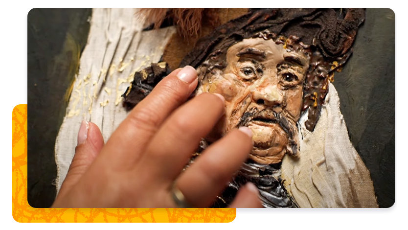 A person experiences a painting by touching it