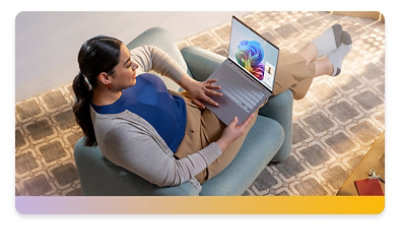 Woman lounging in a chair working on a Surface laptop