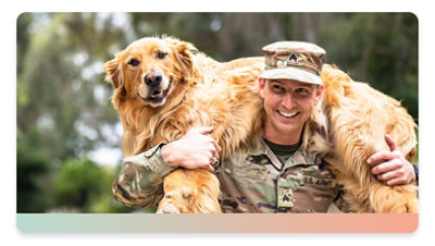 A person in military uniform carries a large dog on their shoulders