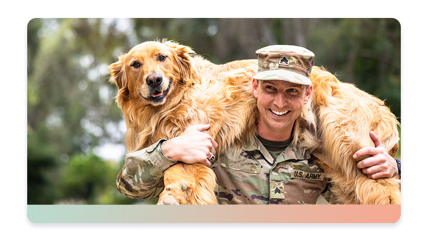 A person in military uniform carries a large dog on their shoulders