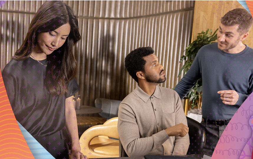 Three colleagues working and talking in an office