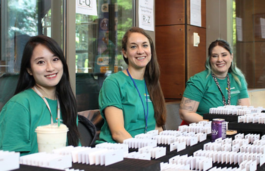 A group of women sitting at a registration table