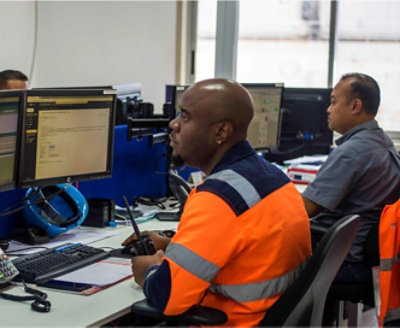 Two men working at computers in an office.