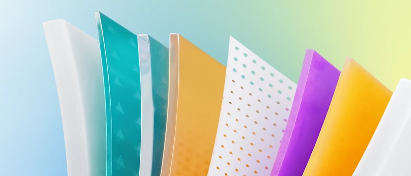 A stack of colorful papers on a blue background.