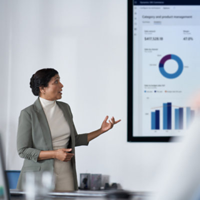 A person giving a presentation in a big screen