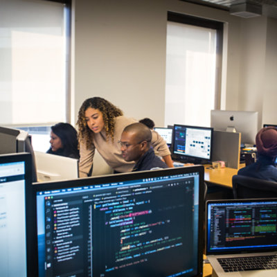 Group of people sitting in the office and working with their system