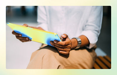 A hand holding a blue and yellow device.