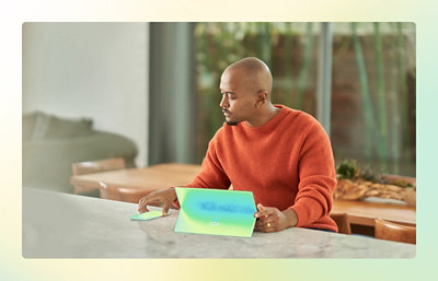 A person sitting at a table with a laptop.