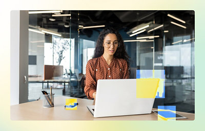 A woman sitting at a desk using a laptop.
