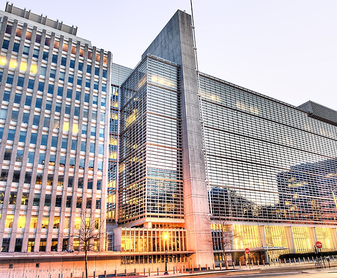 Modern office buildings at twilight with reflective glass facades.