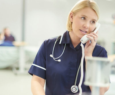 A doctor talking on a phone.