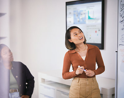 A person holding a pen and looking up