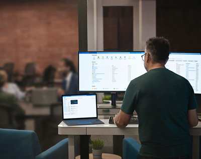 A person sitting at a desk with a computer and a computer