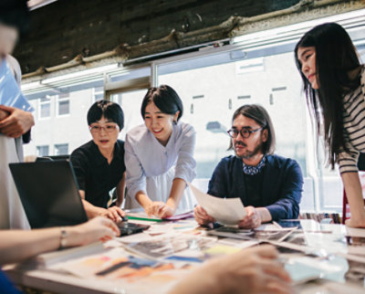 A group of people looking at papers