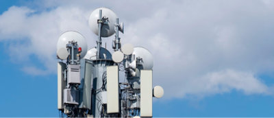 A group of satellite dishes on a tower
