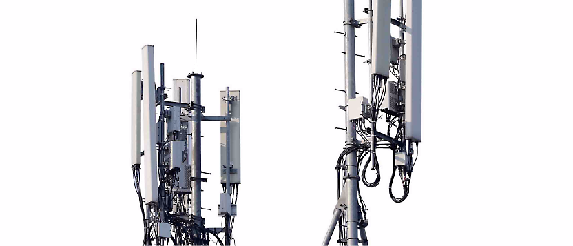 A close-up of several cellular towers