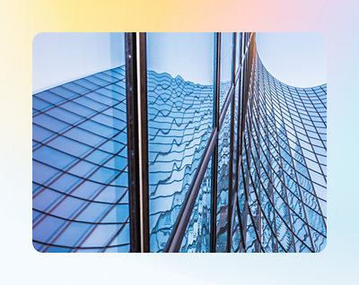 Reflection of a wavy skyscraper facade on an adjacent glass building.