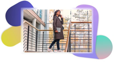 A person walking up stairs while on a call on their mobile phone.