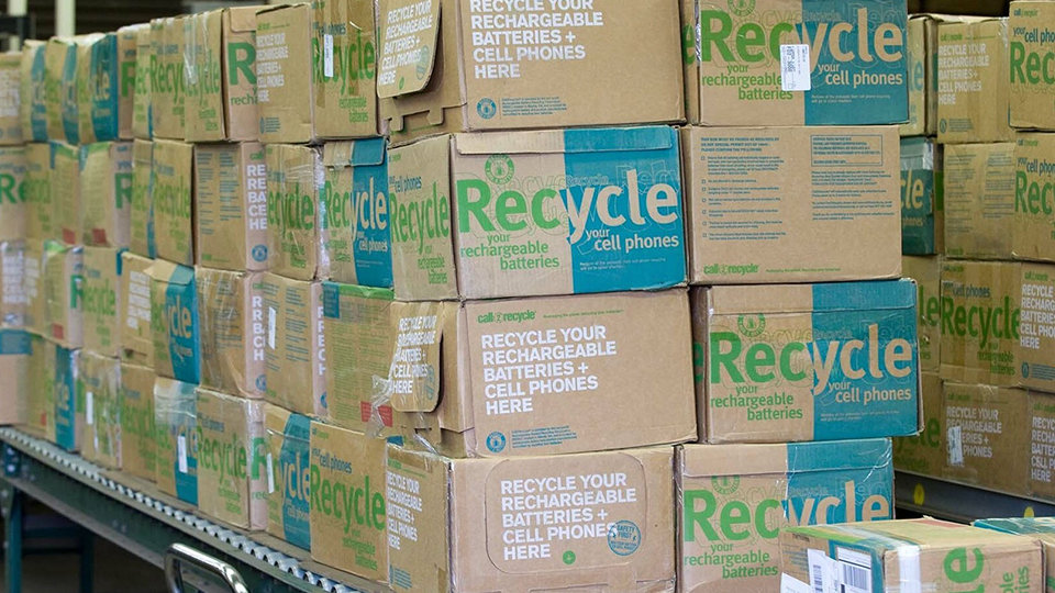 Cardboard boxes labeled ‘Recycle’ for cell phones and batteries.