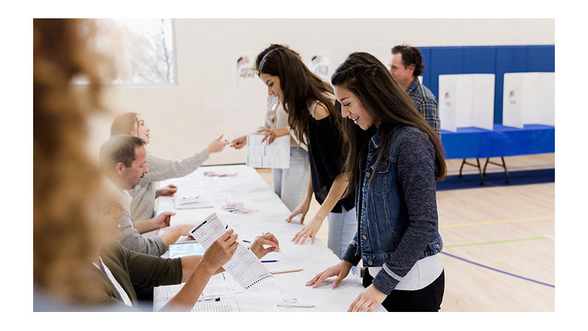 Women stand in row while signing up to vote