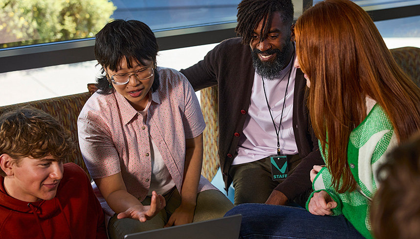 A group of people having a conversation indoors.