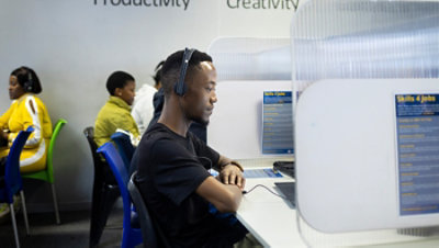 People working at computers in a job skills training center.